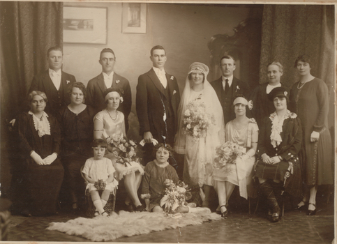 Black & white wedding photo showing whole bridal party & family.