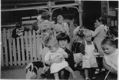 2413.07 - Informal photo of group of mothers and children outside unknown cottage