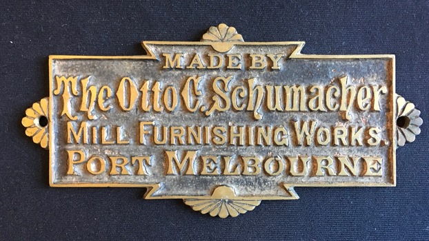 Brass plaque bearing the words "Made by The Otto C Schumacher Mill Furnishing Works Port Melbourne"