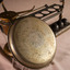A set of manual scales with the pan leading against the base showing many signatures on the bottom.