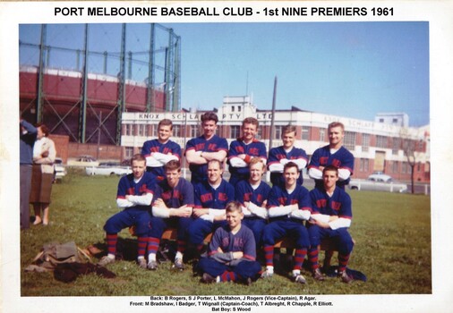 Eleven men and one boy posing in team formation. Five standing, six sitting with boy sitting on the ground in front.