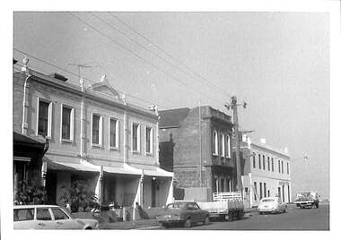 Photograph - Stokes Street, Port Melbourne 1973 showing terrace homes (nos. 20-24), former Freemasons Lodge (no.18) and Sandridge Hotel (formerly Freemasons Hotel) on corner of Beach Street, Janet and Allen Walsh, 1973