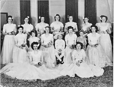 A group of women in white dresses