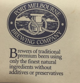 Image of a wharf bollard with ship's rope around the centre of the bollard inside a oval shape with the words Port Melbourne above and Brewing Company below. The wording outside the oval shape - Brewers of traditional premium beer using only the finest natural ingredients without additives or preservatives.