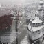 Black & white photo of a ship docked at a wharf, crowds of people are also on the pier.