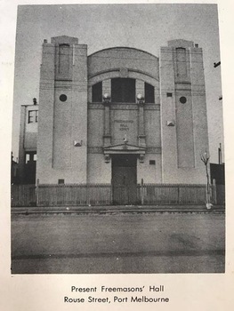 Imposing ornamental building with two towers and an arched roof.