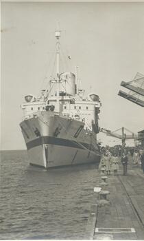 Photo shows the  "Oranje" bow when she was berthed at Princes Pier. You can also see the gangways connected to the arrival building and a. group of people having their photos taken in front of the ship. 