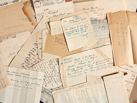 A close up view of an unorganised pile of notes and letters of varying sizes. Some are small scraps of paper, some are envelopes and some are full letters. Most of the details are handwritten but one of the letters is typed.