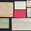 A selection of handwritten notes of varying sizes displayed neatly on a black background.