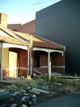 Two small partially demolished brick cottages
