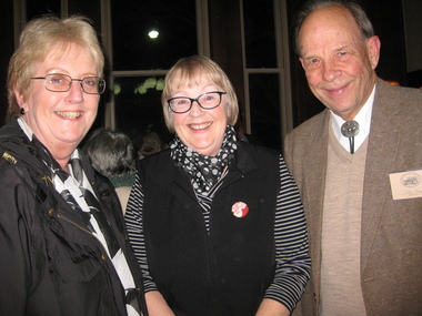 Two women and a man smile for the camera.