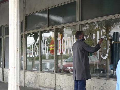 3493.10 - Doug Faram painting 'CLOSING DOWN up to 15% OFF' at Faram Bros Hardware Store
