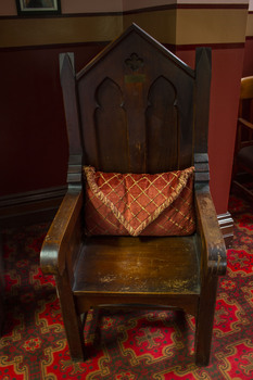 3903 - Sister Norma Barnett's chair and cushion from Melbourne City Mission, Port Melbourne branch