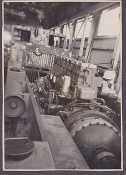 Interior of factory including large diesel engine