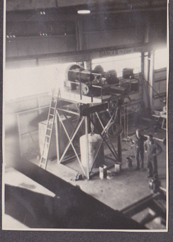 Interior of Malcolm Moore fitting shop with two workers