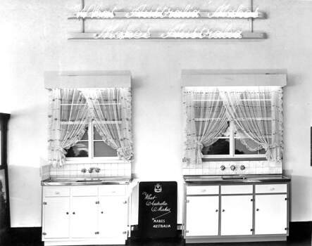 Display of sinks under a neon banner 'What Australia Makes, Makes Australia'.