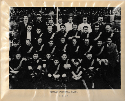 Group of men posing in four rows in typical football team formation.