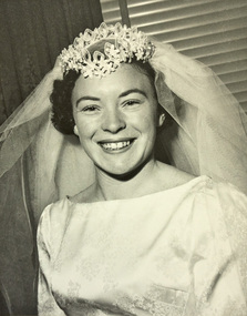 Head and shoulders of a woman wearing a wedding dress