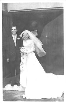 A bride and groom standing in a doorway