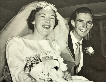 A close up view of a bride and groom in a car