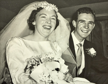 A close up view of a bride and groom in a car