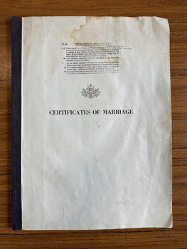Booklet with a light blue cover and dark green binding