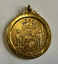 Gold-coloured medallion with a crest and "City of Port Melbourne Victoria" around the edge.