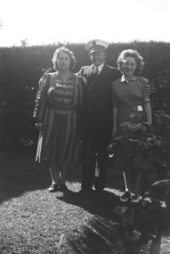 Photograph - Norma Madeline Watters on right, Ellen Patricia on left.  Back garden during WW2.  Unidentified male in middle
