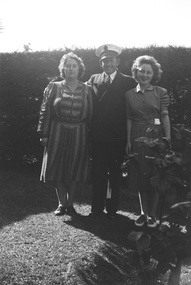 Photograph - Norma Madeline Watters on right, Ellen Patricia on left.  Back garden during WW2.  Unidentified male in middle