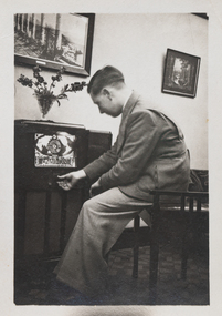 Photograph - Robert Cornelius Watters at the controls of the prized radio in Garden City home c 1937