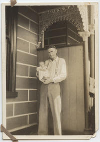 Photograph - Fred Nicholson as baby being held by father George, 1940s