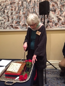Photograph - Pat GRAINGER, cutting a cake to celebrate her Order of Australia Medal, 2016
