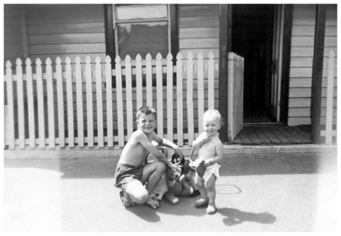 Photograph - Ray Schink with baby sister, Jenny, outside house in Heath Street, Port Melbourne, 1960