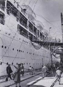 Photograph - Throwing farewell steamers as ship leaves Station Pier
