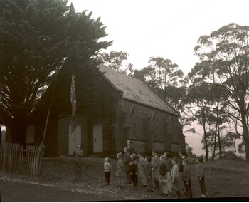 Church Children raising flag outside old church
