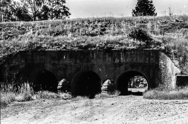 Film - Photograph by Herb Richmond. ca 1971, Creswick- Three Arch Bridge carrying the railway embankment. Two traffic lanes and a waterway. West of Creswick off the road to Bald Hills