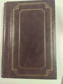 Cover of brown photo album with gold embossing.
