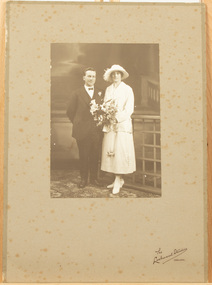 Studio photograph of a bride and groom. 
