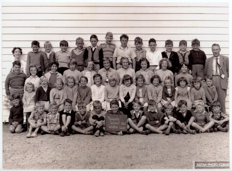 group of standing and seated school pupils arranged for a class photograph 