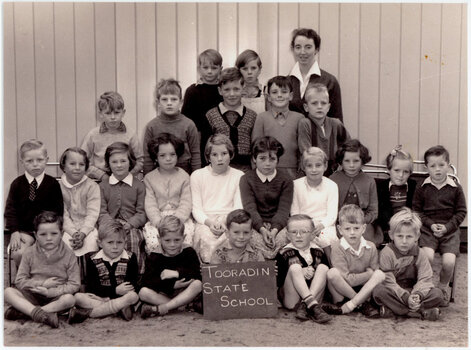 group of standing and seated school pupils arranged for a class photograph 