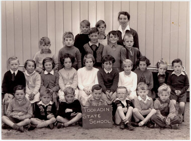 group of standing and seated school pupils arranged for a class photograph 