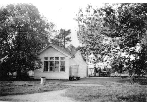 Front of school building showing grounds.