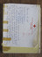Yellow note book with handwritten note attached to the cover