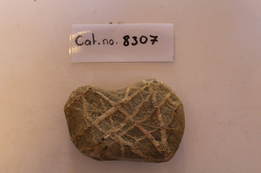 Criss-crossed piece of bluestone/basalt