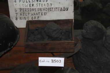 Coal in a wooden tray