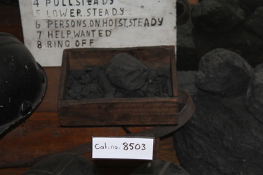 Coal in a wooden tray