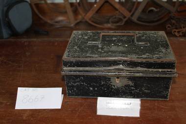 A lockable tin box with handle on hinged lid