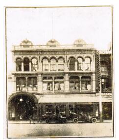 An old sepia photograph of a city building.