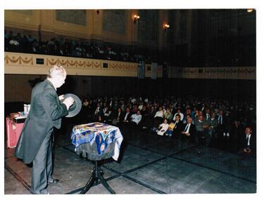A magician is on the stage performing for an audience.