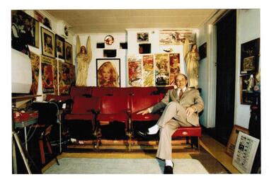 A man is seated in a home cinema 